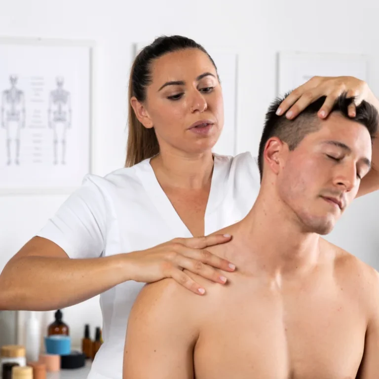 Chiropractor adjusting a man's neck and shoulder for musculoskeletal relief.